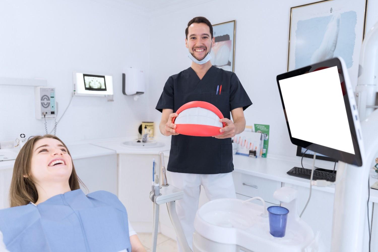Dentist explaining dental treatment to a smiling patient
