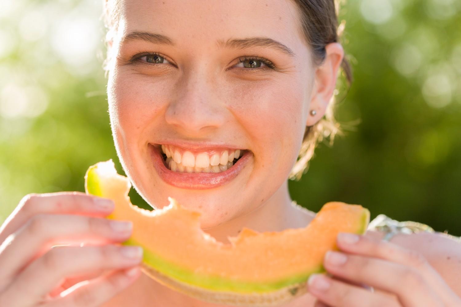 women eating melon